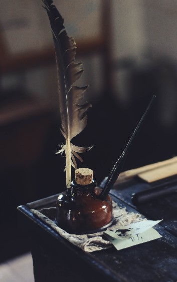 Writing quill in an inkpot